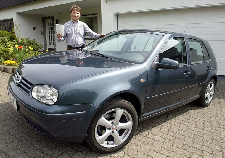 Ebay seller Reimund Halbe shows the Volkswagen Golf and the official documents that show the former owner, Cardinal Joseph Ratzinger.